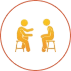 Two figures sitting and talking, circle icon.
